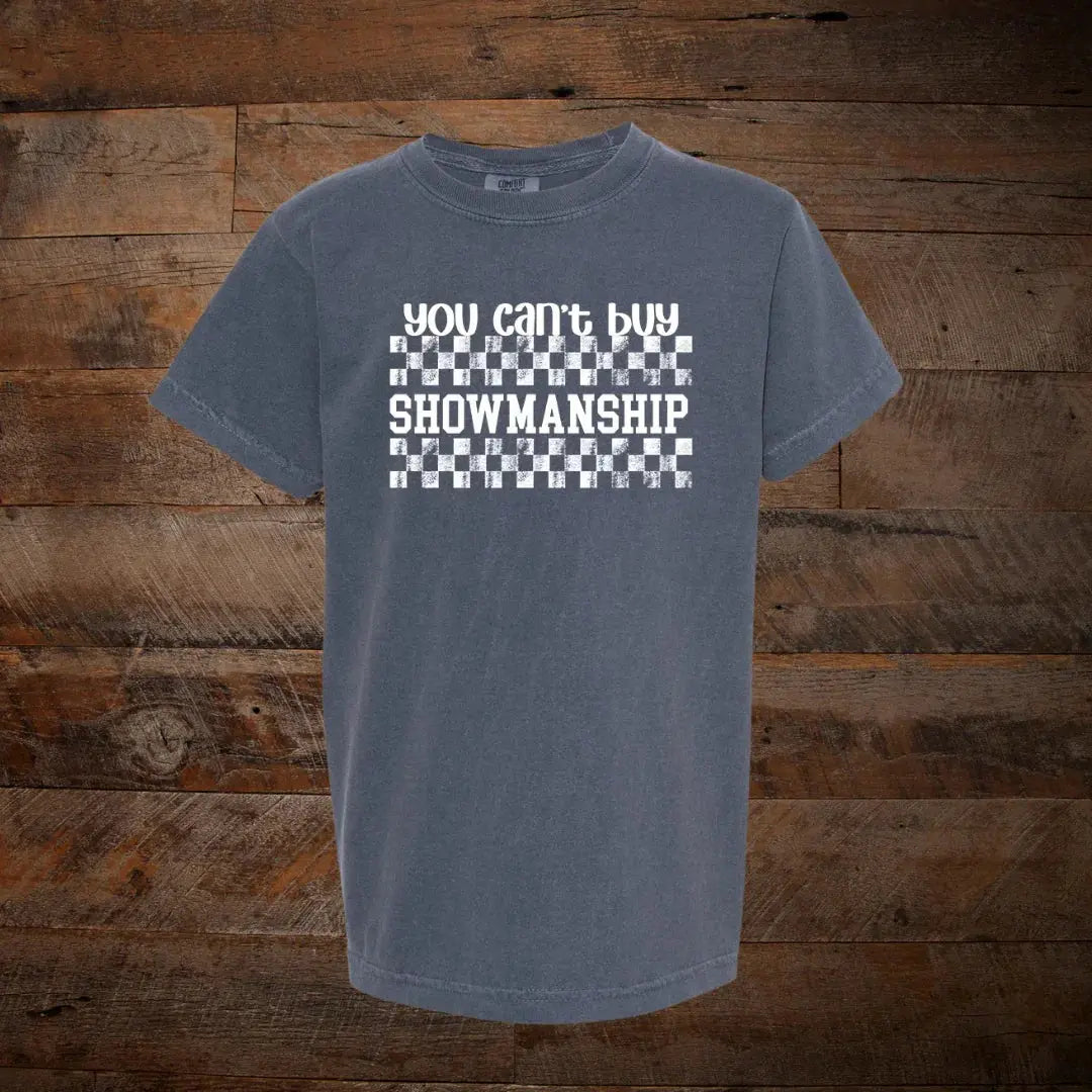 Gray t-shirt with 'you can't buy showmanship' text and checkerboard pattern on wood background