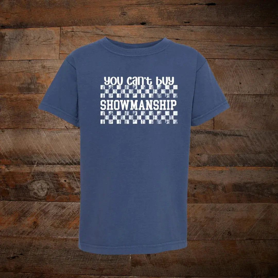 Blue t-shirt with 'You can't buy showmanship' text and checkered pattern, rustic wood background