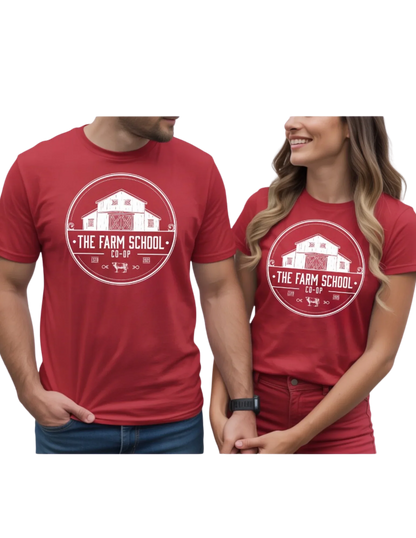 Man and woman wearing matching red graphic t-shirts with The Farm School Co-Op barn logo.