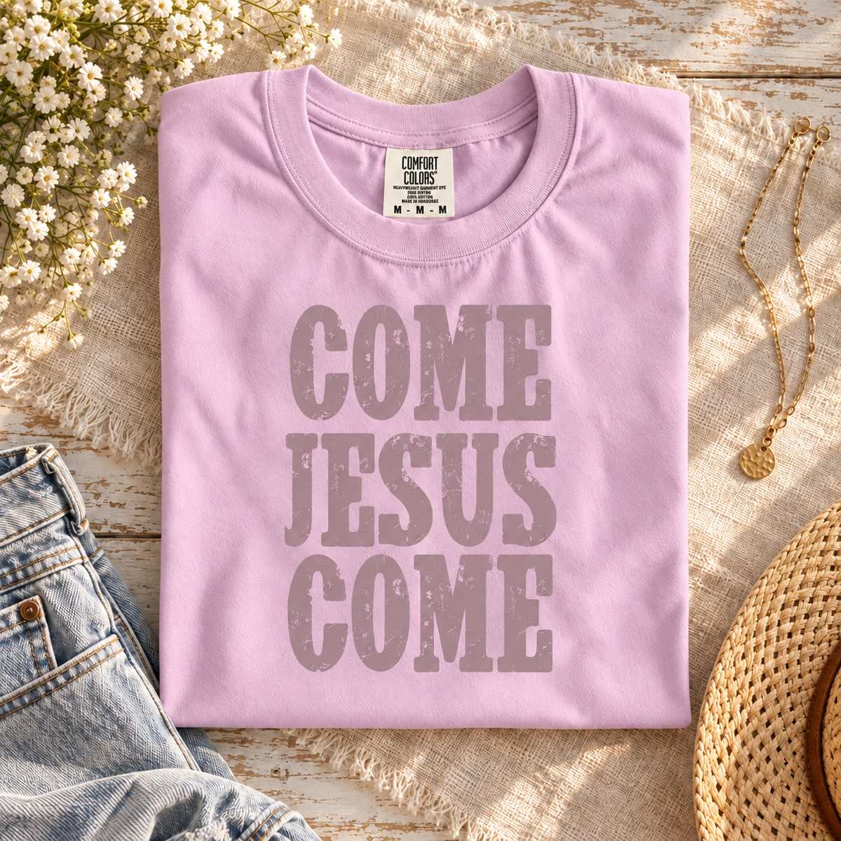 Come Jesus Come Orchid tee with muted mauve print styled on cream linen